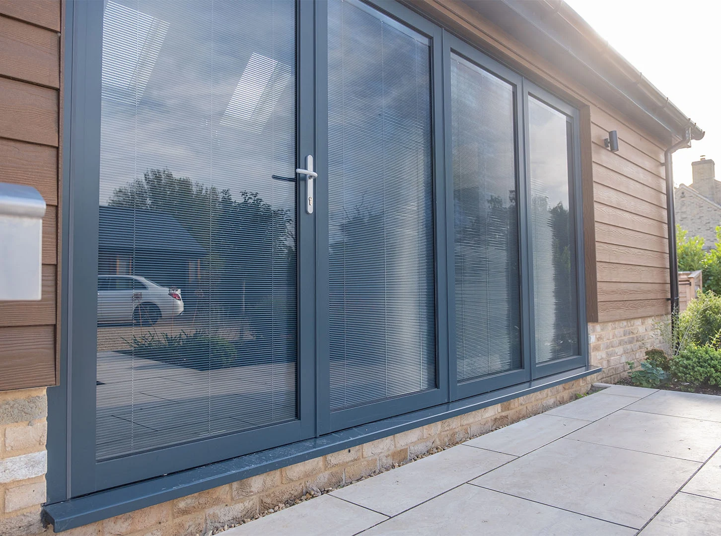 Anthracite patio doors with integral blinds viewed from outside