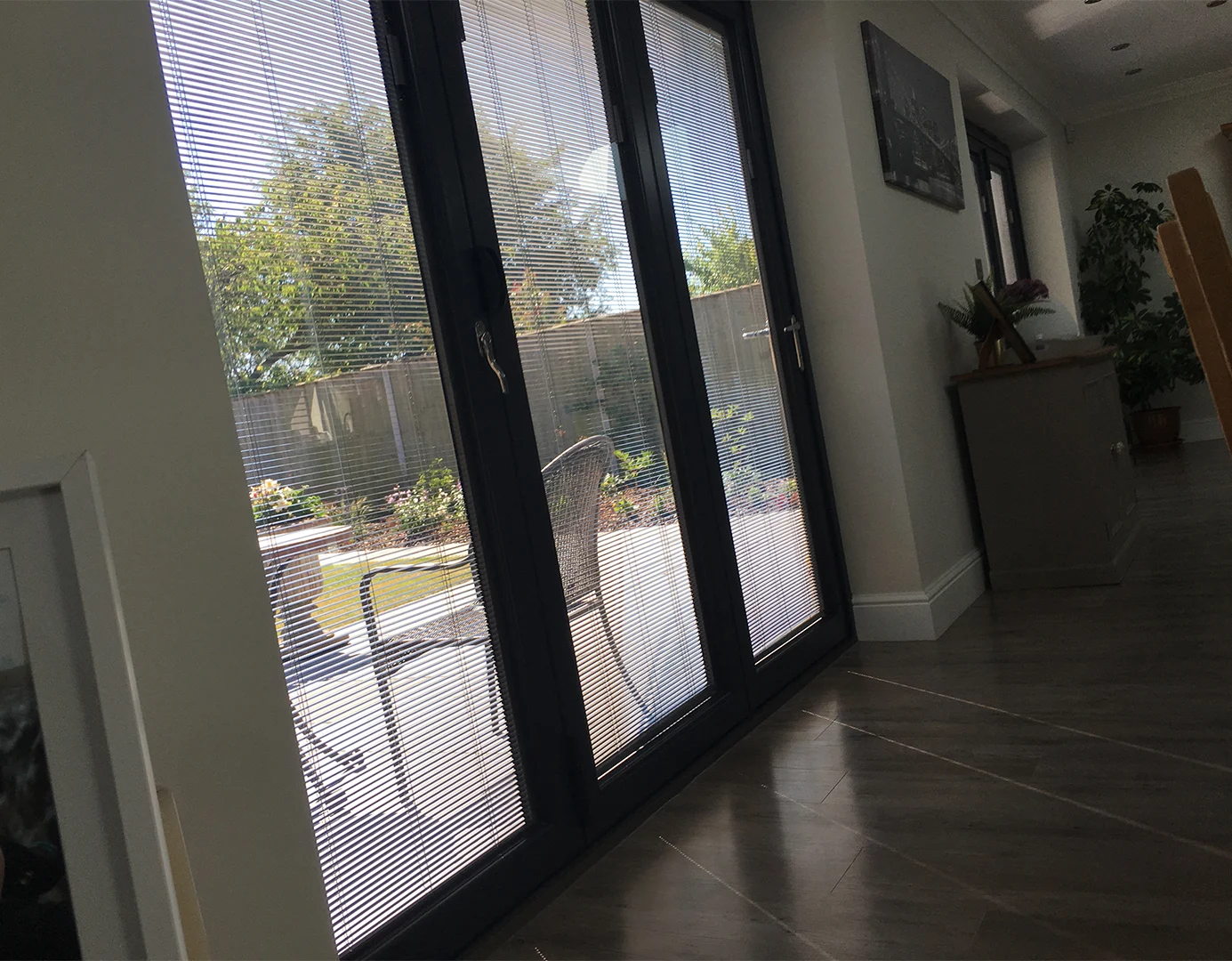 Dark framed glazed doors with integral blinds sealed inside the glass units