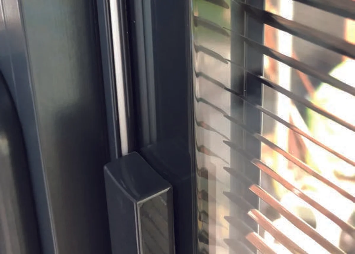 Close-up of an integral blind control beside a glazed unit